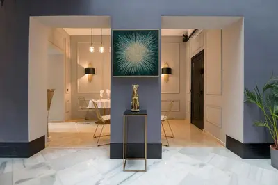 a hallway with a statue on a table in a room at Boutique Suites in Arcos de la Frontera