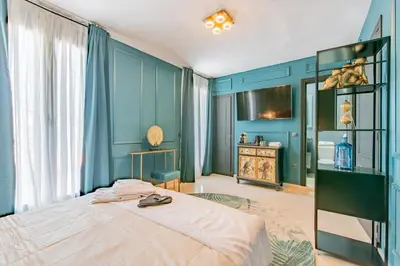 a bedroom with blue walls and a bed at Boutique Suites in Arcos de la Frontera