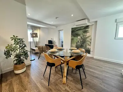 a dining room with a table and chairs at Apartamentos La Muralla Grupo AC Gestion in Cádiz