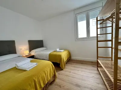 a room with two beds and a ladder at Apartamentos La Muralla Grupo AC Gestion in Cádiz