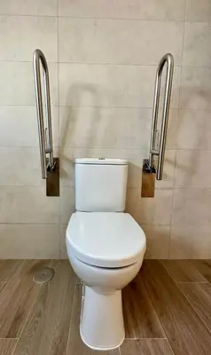 a bathroom with a white toilet in a room at Apartamentos La Muralla Grupo AC Gestion in Cádiz