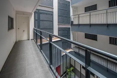 a balcony of an apartment building with a staircase at Apartamento La Luna Nueva en Cádiz in Cádiz