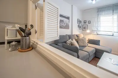 a living room with a couch and a window at Apartamento La Luna Nueva en Cádiz in Cádiz