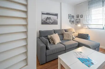 a living room with a couch and a table at Apartamento La Luna Nueva en Cádiz in Cádiz