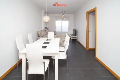 a dining room with a white table and white chairs at El Anfitrión - Paleobull Castillo in Sanlúcar de Barrameda