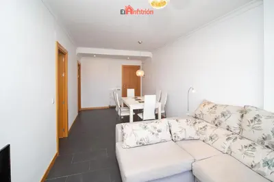 a living room with a white couch and a table at El Anfitrión - Paleobull Castillo in Sanlúcar de Barrameda