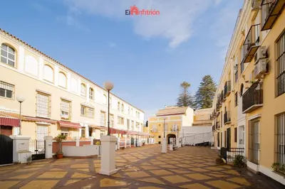 an empty street in a city with buildings at El Anfitrión - Paleobull Castillo in Sanlúcar de Barrameda