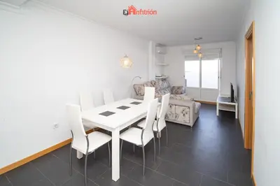 a dining room with a white table and chairs at El Anfitrión - Paleobull Castillo in Sanlúcar de Barrameda
