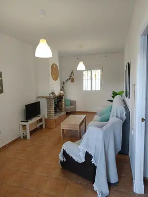 a living room with a couch and a tv at Casita Alejandro in Chiclana de la Frontera