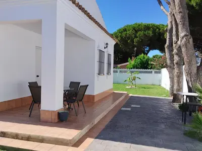 a patio with chairs and a table in a house at Casita Alejandro in Chiclana de la Frontera