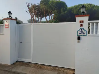 a white fence with a no entry sign on it at Villa Mencal in Chiclana de la Frontera
