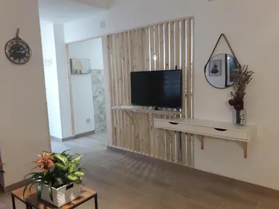 a living room with a flat screen tv on a wall at El Rincón del Mercado in Cádiz