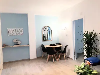 a dining room with a table and chairs at El Rincón del Mercado in Cádiz