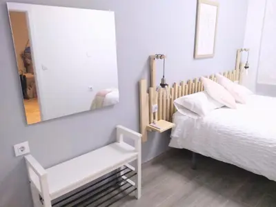 a bedroom with a bed and a mirror at El Rincón del Mercado in Cádiz