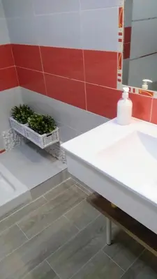 a bathroom with a white sink and a mirror at El Rincón del Mercado in Cádiz