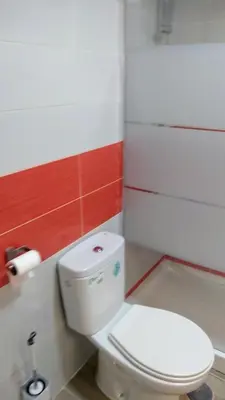 a bathroom with a white toilet in a room at El Rincón del Mercado in Cádiz