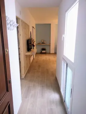an empty hallway with a hard wood floor and a door at El Rincón del Mercado in Cádiz
