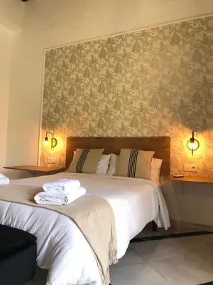 a bedroom with a large bed with a wall mural at Apartamentos Makao Puerta del Olivillo in Jerez de la Frontera