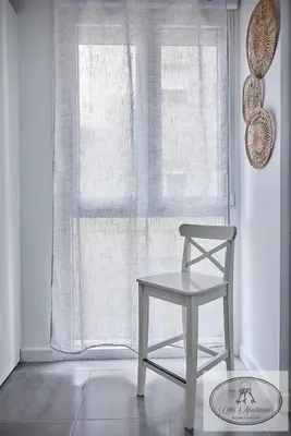 a white chair sitting in front of a window at Apartamento Playa Recreo Little Apartments in Cádiz