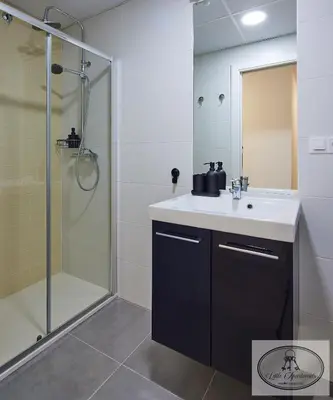 a bathroom with a sink and a shower at Apartamento Playa Recreo Little Apartments in Cádiz