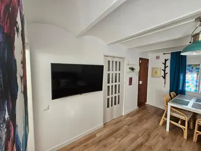a living room with a flat screen tv on a wall at Plaza de las Bodegas in El Puerto de Santa María