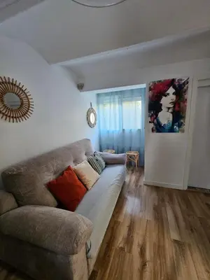 a living room with a couch and a painting on the wall at Plaza de las Bodegas in El Puerto de Santa María