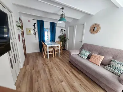 a living room with a couch and a table at Plaza de las Bodegas in El Puerto de Santa María