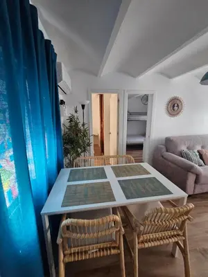 a dining room with a table and two chairs at Plaza de las Bodegas in El Puerto de Santa María