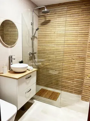 a bathroom with a glass shower and a sink at A menos d 1 min d plaza cabildo in Sanlúcar de Barrameda