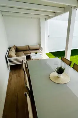 a living room with a couch and a table at A menos d 1 min d plaza cabildo in Sanlúcar de Barrameda