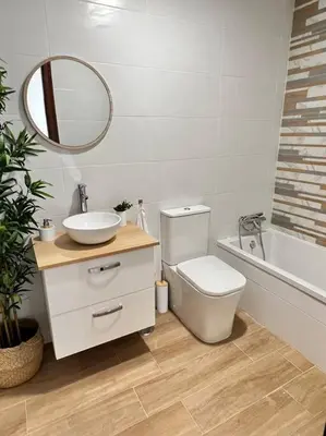 a bathroom with a sink and a toilet and a mirror at A menos d 1 min d plaza cabildo in Sanlúcar de Barrameda