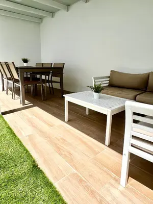 a living room with a couch and a table and chairs at A menos d 1 min d plaza cabildo in Sanlúcar de Barrameda