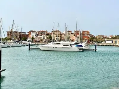 a group of boats docked at a dock in a harbor at GATU Sherry, junto puerto deportivo y playa in El Puerto de Santa María