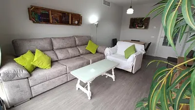 a living room with a couch and a table at Kiana Mirador Jerez con parking in Jerez de la Frontera