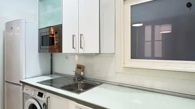 a kitchen with two stools in front of a window at Palacio Alameda Heart Of Cadiz GRUPO AC Gestion in Cádiz