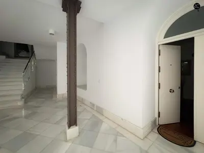 a bedroom with a bed and a table with a lamp at Palacio Alameda Heart Of Cadiz GRUPO AC Gestion in Cádiz