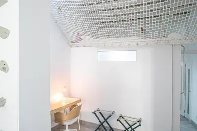 a room with a wooden desk and a white wall at Apartamento El Cobijo de Cádiz in Cádiz