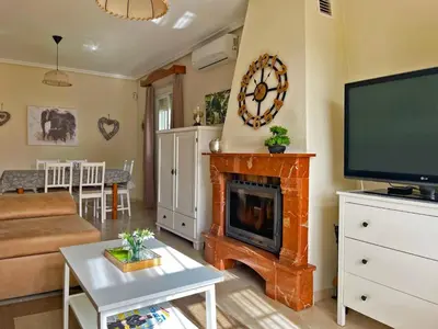 a living room with a fireplace and a flat screen tv at Casa Los Henke - Ole Solutions in El Puerto de Santa María