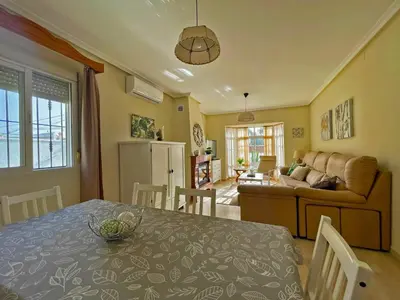 a kitchen and living room with a table and a couch at Casa Los Henke - Ole Solutions in El Puerto de Santa María