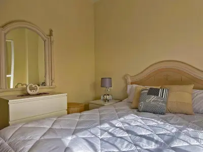 a bedroom with a large white bed with a large mirror at Casa Los Henke - Ole Solutions in El Puerto de Santa María