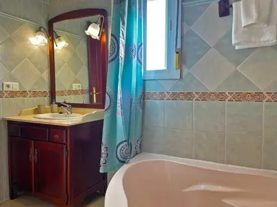 a bathroom with a tub and a sink at Casa Los Henke - Ole Solutions in El Puerto de Santa María