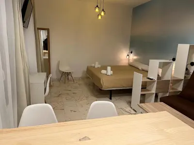a living room with a couch and a table and chairs at Apartamento El Alquimista in Cádiz