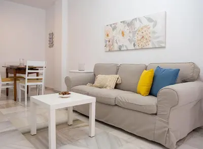 a living room with a couch and a table at Sibs Sanlucar-San Juan-Cabildo Centro Playa Familias Amigos in Sanlúcar de Barrameda