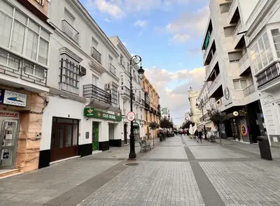 an empty street in a city with buildings at Sibs Sanlucar-San Juan-Cabildo Centro Playa Familias Amigos in Sanlúcar de Barrameda