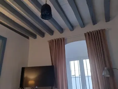 a living room with a tv and a window at La casa de loto in Alcalá de los Gazules