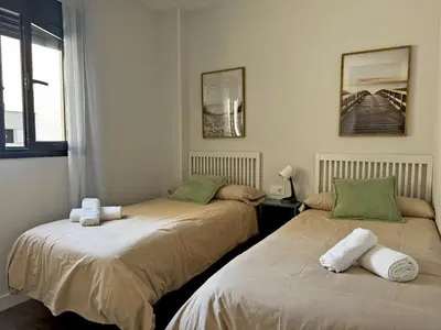 a bedroom with two beds with towels on them at Apartamento Alazán - Ole Solutions in Jerez de la Frontera