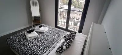 a bedroom with a black and white bed with a window at Kiana Mirador Sherry, parking gratis in Jerez de la Frontera