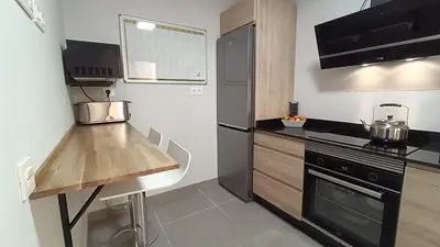 a kitchen with a counter and a stove top oven at Kiana Mirador Sherry, parking gratis in Jerez de la Frontera