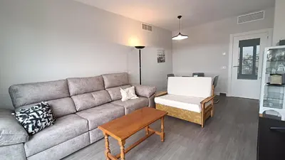 a living room with a couch and a table at Kiana Mirador Sherry, parking gratis in Jerez de la Frontera
