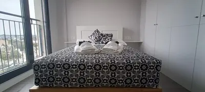 a bedroom with a bed with a black and white blanket at Kiana Mirador Sherry, parking gratis in Jerez de la Frontera